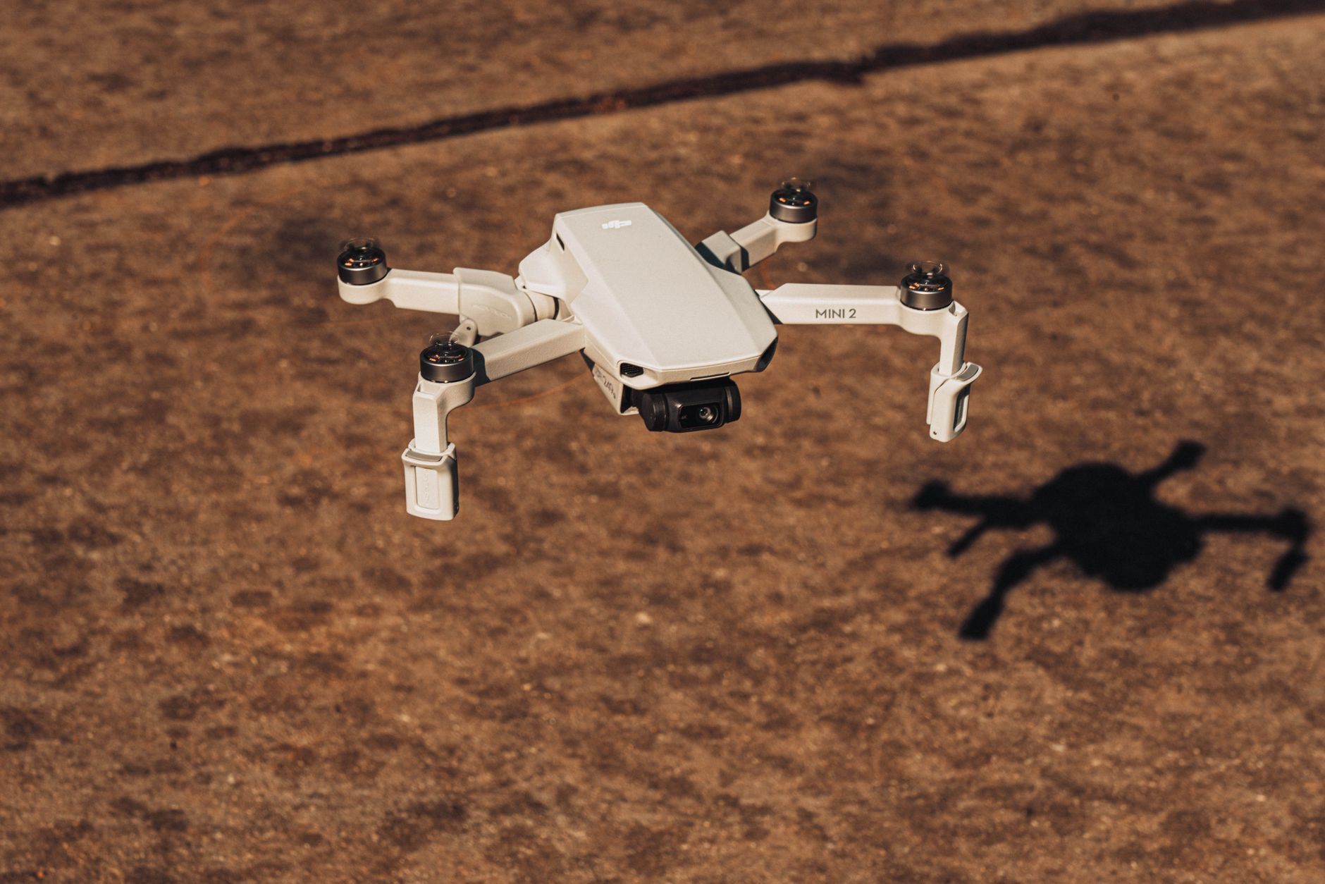 Skydio 2 Plus drone following mountain biker through forest trail