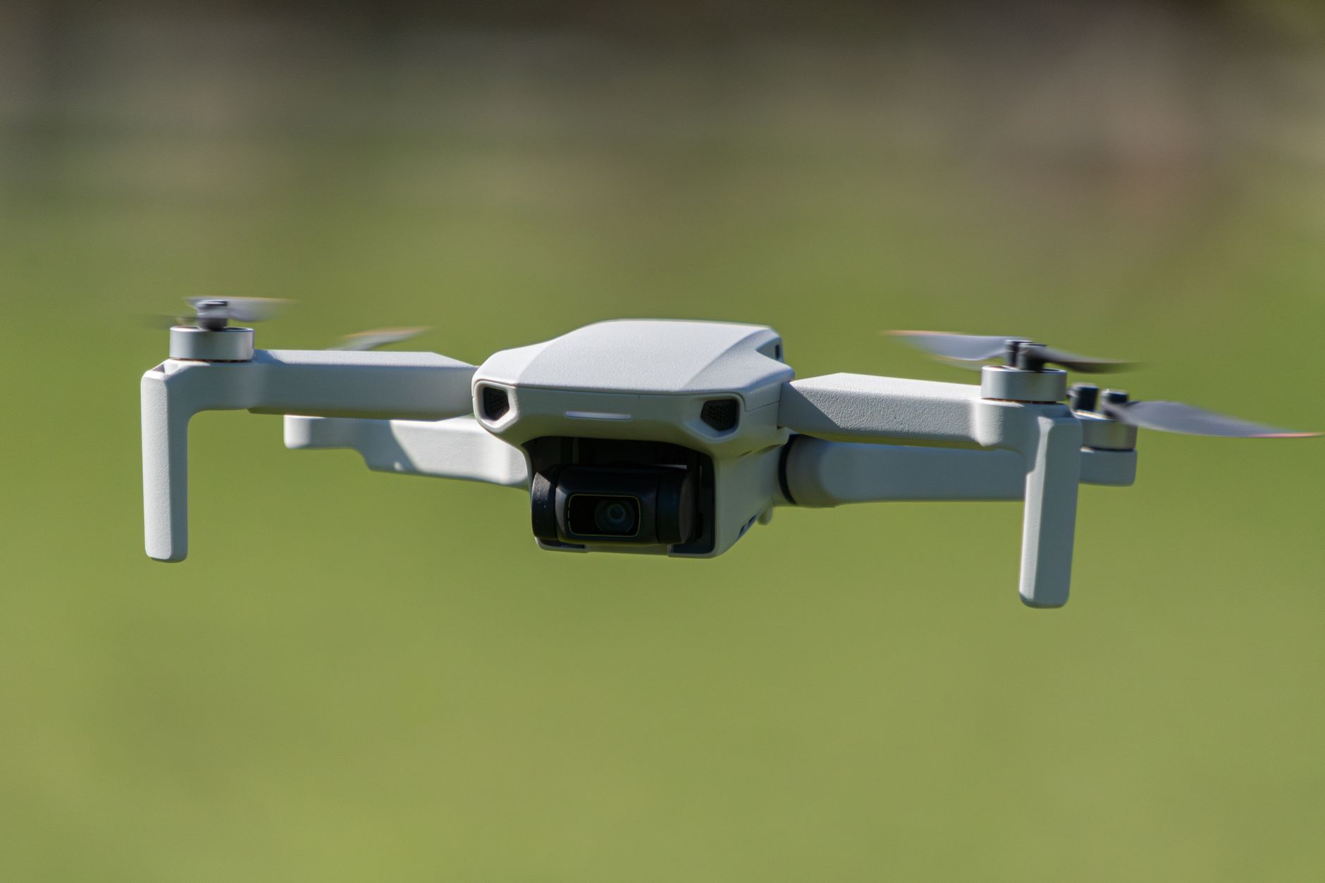 DJI Mavic 3 Pro triple camera drone hovering in studio light