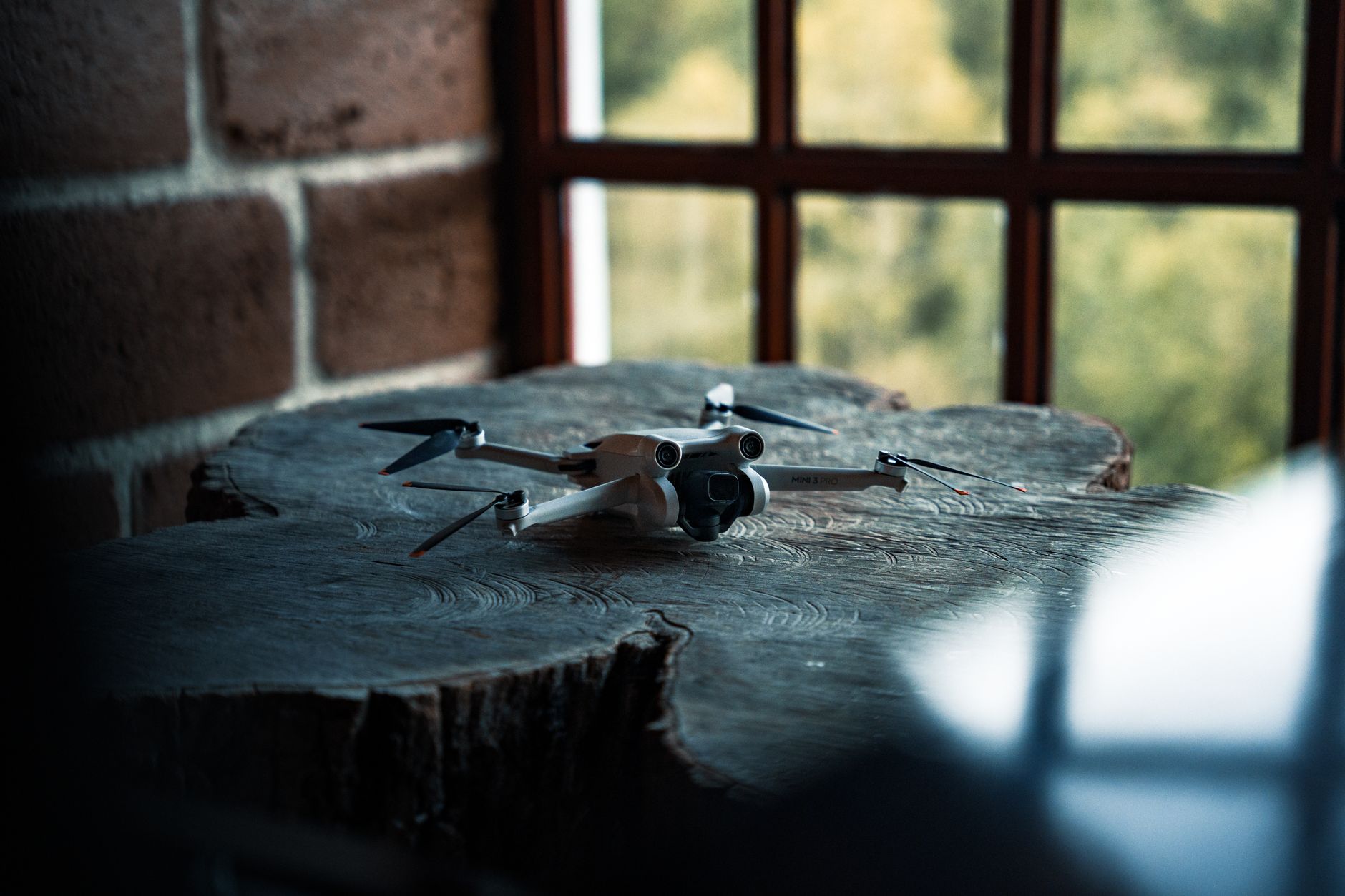 Potensic Atom compact drone resting on wooden table