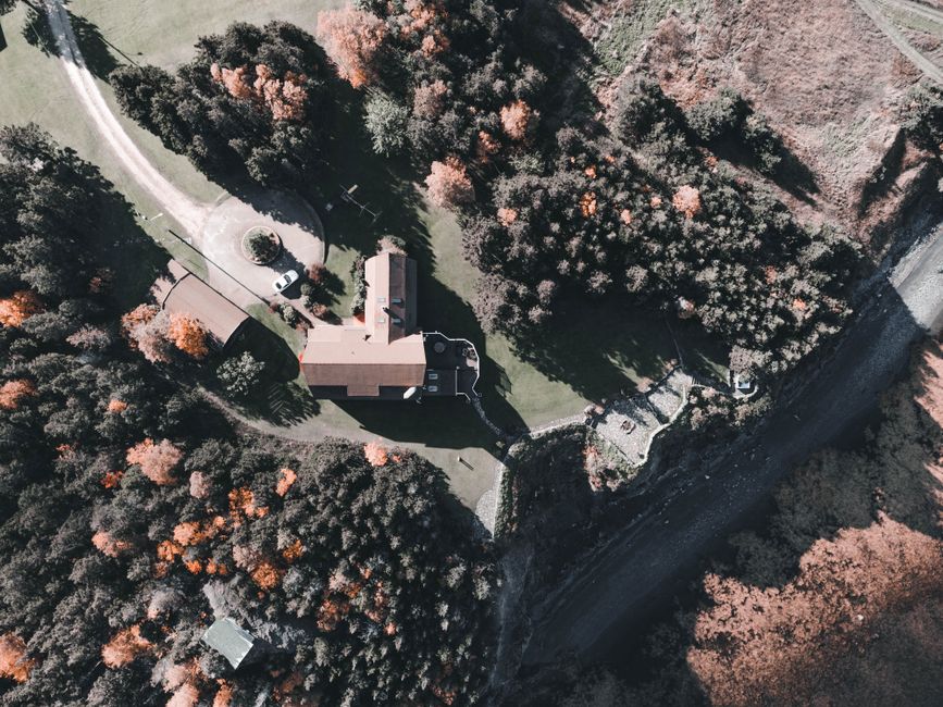 Drone capturing aerial photos of a luxury house during golden hour