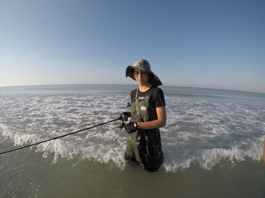 Fishing drone releasing bait line above dark blue ocean water