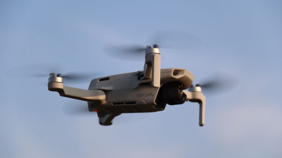 DJI Avata 2 ready-to-fly FPV drone hovering near trees