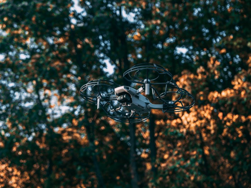 DJI Matrice 30T thermal drone hovering near a utility tower