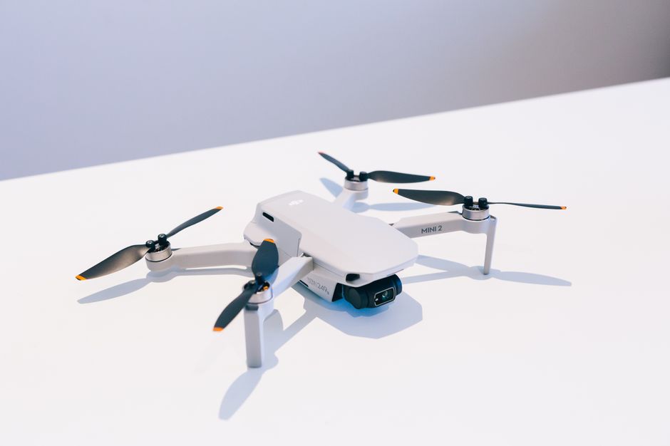 DJI Mini 5 Pro flying above a mountain trail