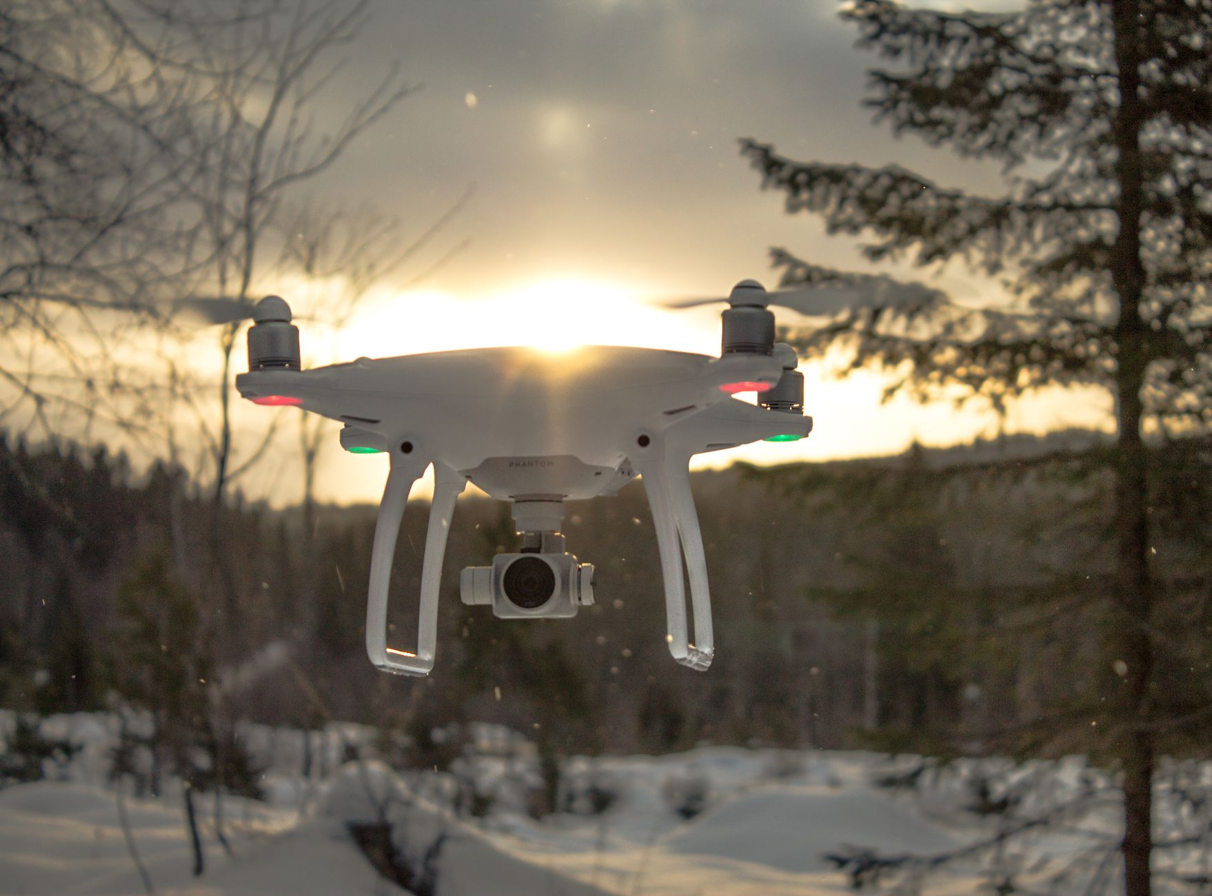 DJI Mini 4 Pro held by pilot before takeoff in park