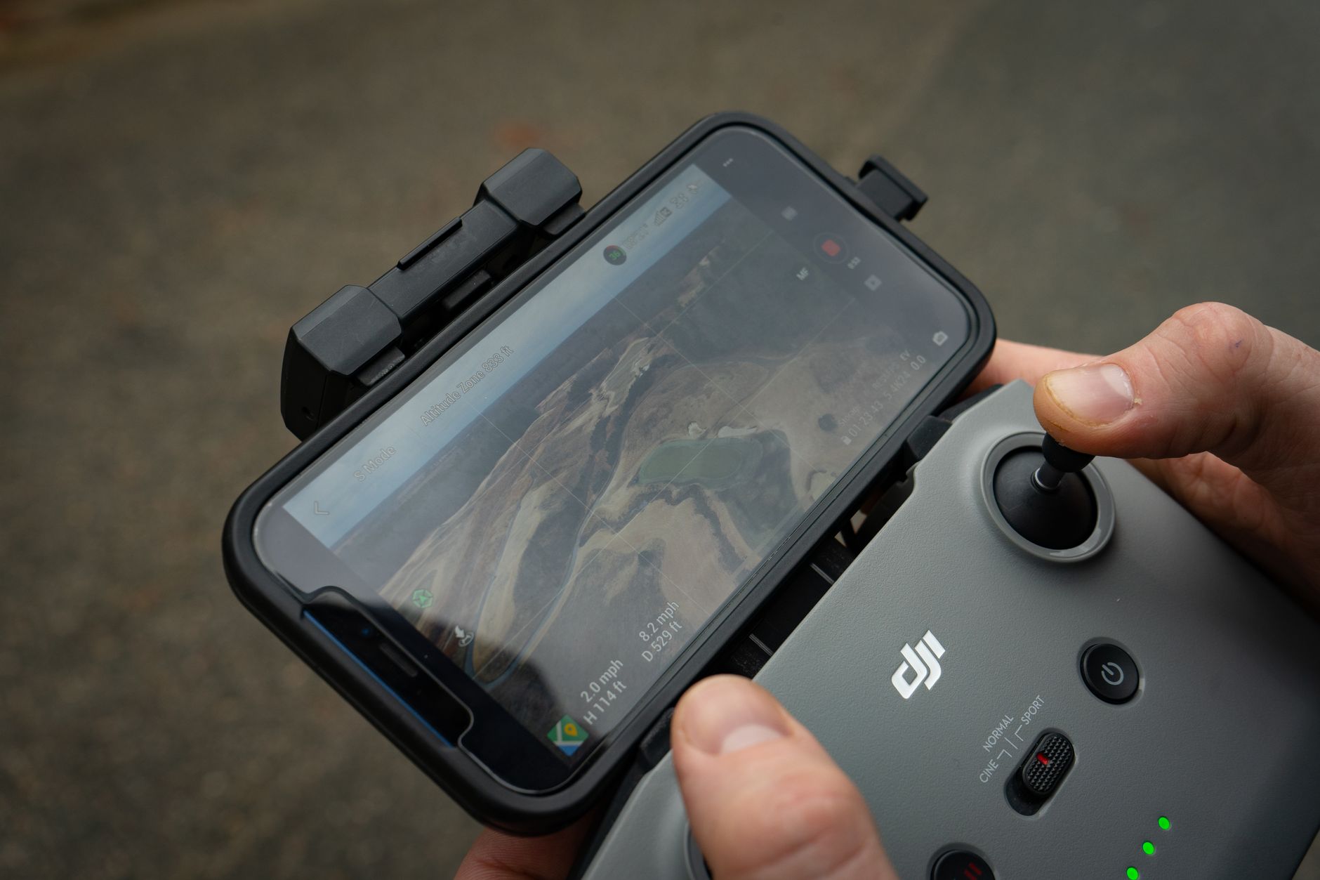 A pilot holding a drone battery to warm it before flying in cold weather.