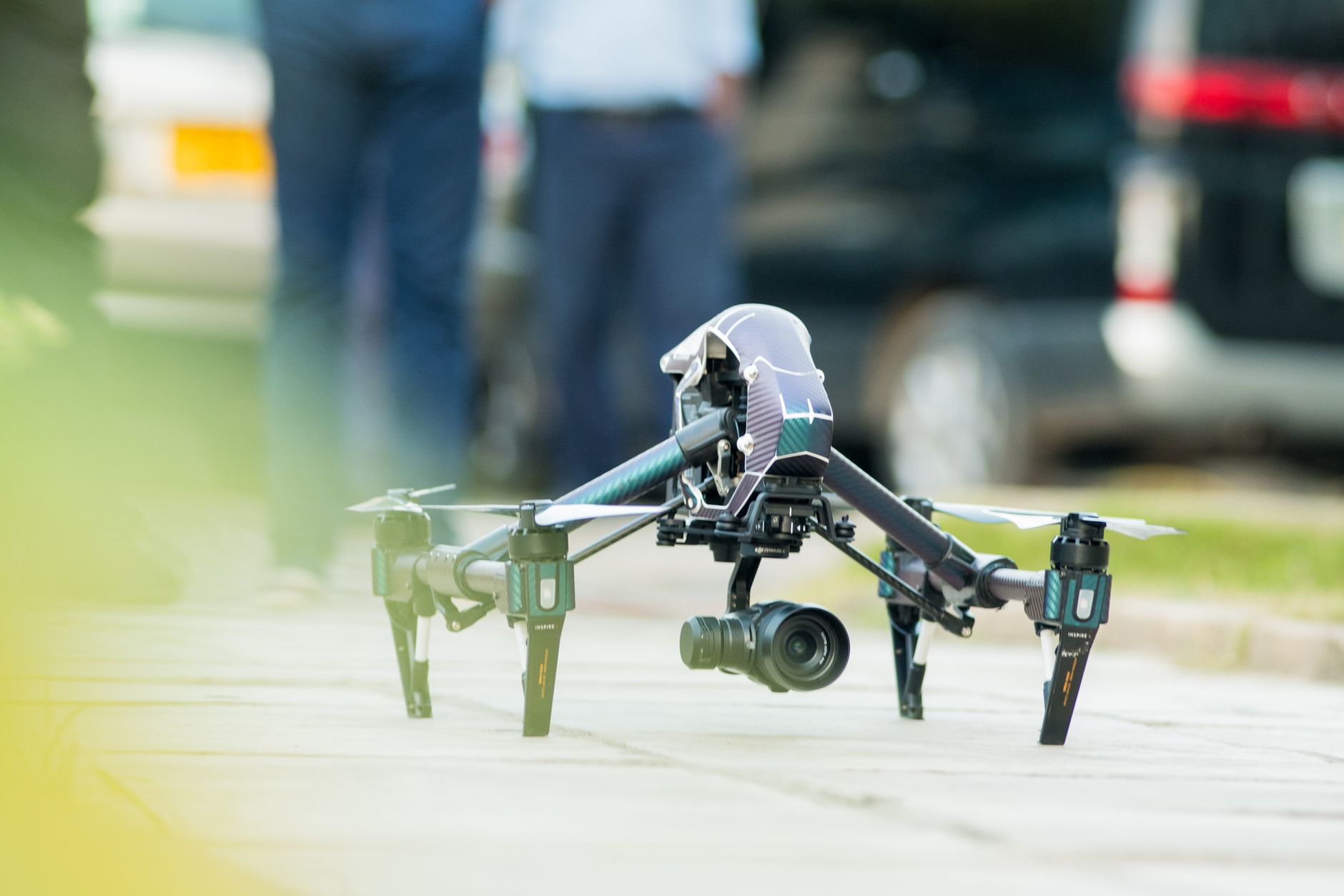 Recreational drone pilot flying a compact drone in an open park