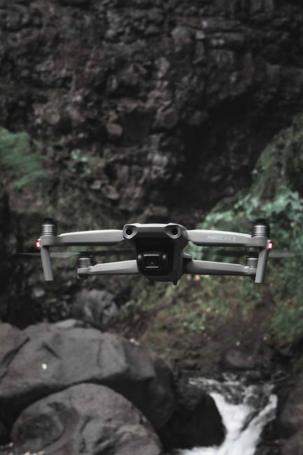 Beginner drone with propeller guards sitting on grass before first flight