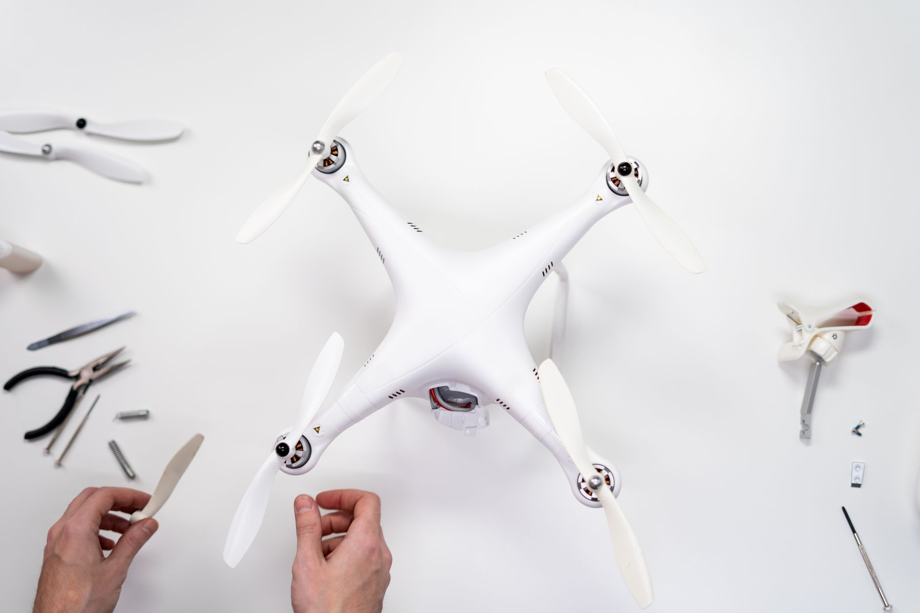 Drone pilot reviewing a flight and maintenance logbook at a table.